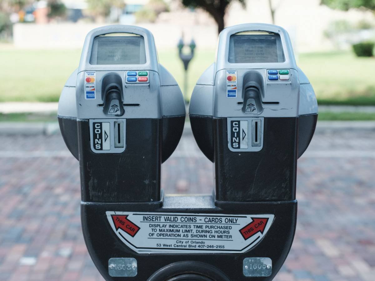 Parking meters on a street, representing Hawaii parking rules that apply to rental cars