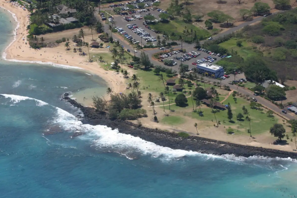 Aerial view of Poipu Beach Park and its parking lots on Kauai